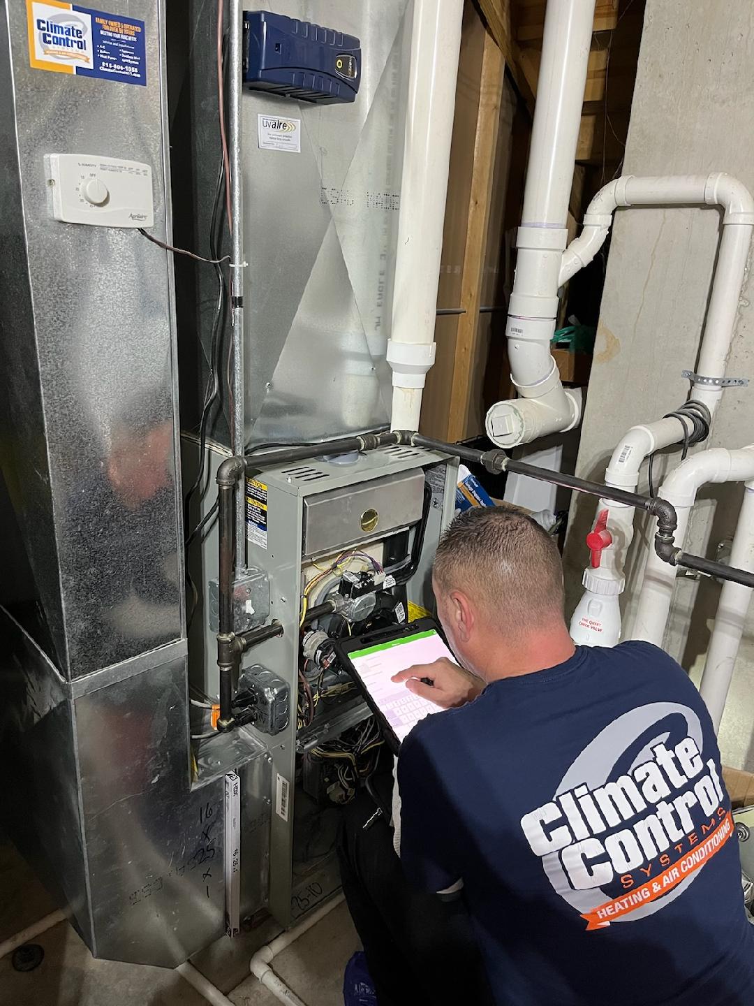 Technician troubleshooting a furnace